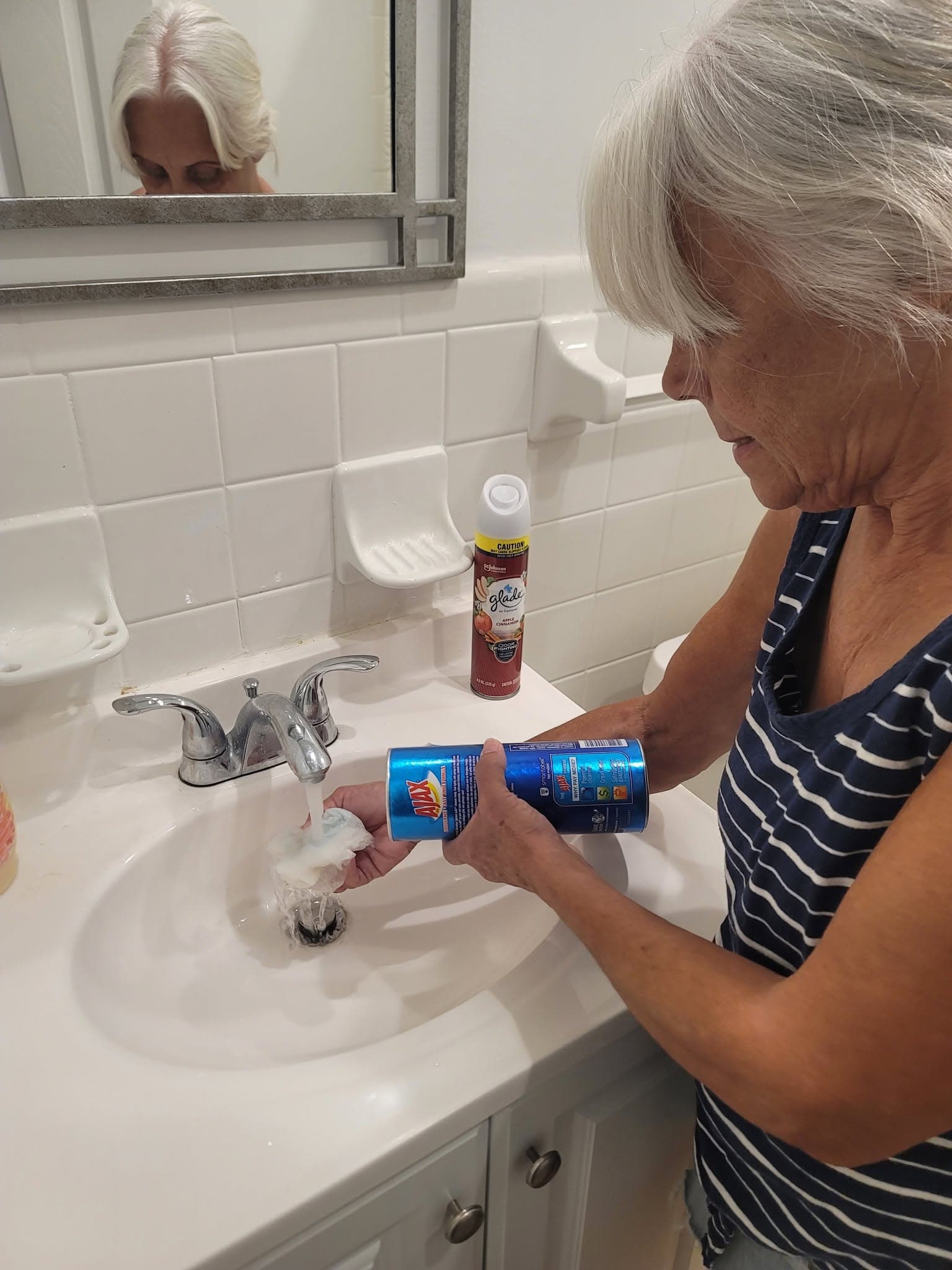 Cleaner scrubbing a bathroom sink and vanity